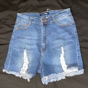 Fashion Nova - Take a hike ripped denim shorts. Size 11. Color medium blue wash